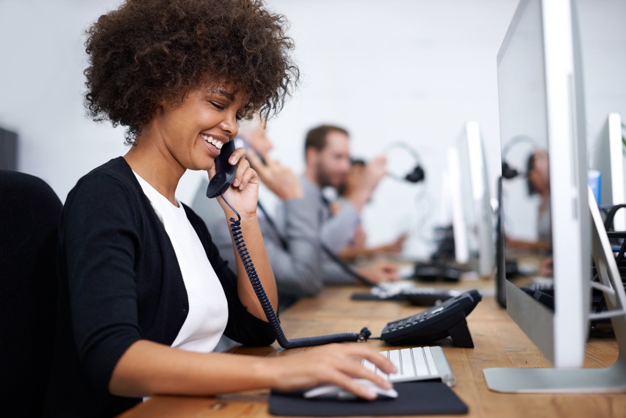 Female sales representative on the phone providing excellent customer service - gaining additions to her sales commission.